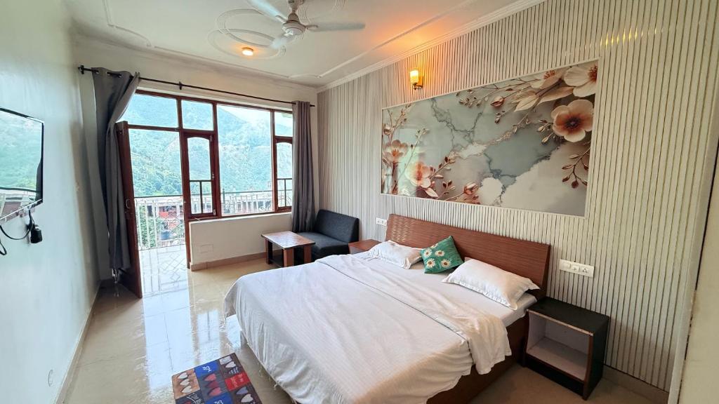 a bedroom with a bed and a painting on the wall at Backpacker Inn Mcleod in Dharmsāla