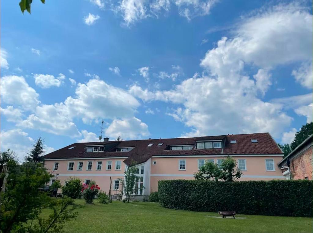 a large white building with a red roof at Lüsser Landsitz in Bad Belzig