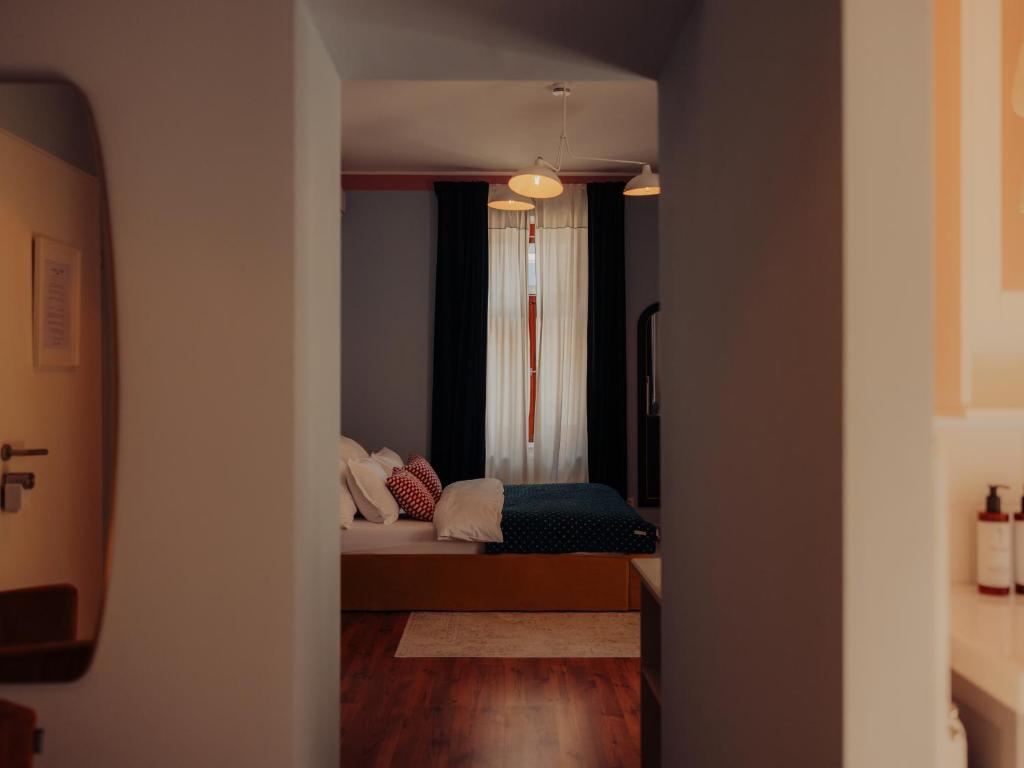 a view of a bedroom with a bed and a window at Oak House Vienna - Boutique Guesthouse near Meidling Station in Vienna