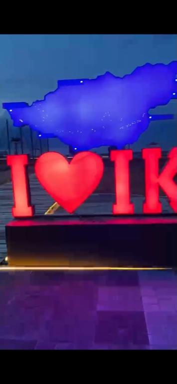 a red heart on a stage with the word love at Этно House in Tong
