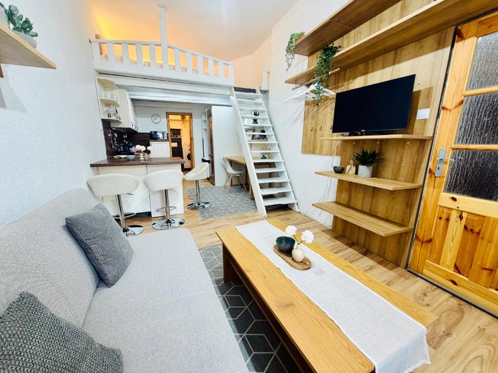 a living room with a couch and a flat screen tv at Apartmány pod zvonicí, Vimperk in Vimperk