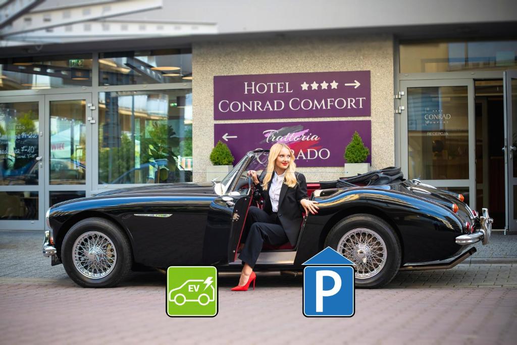 a woman sitting in the back of a car at Hotel CONRAD Comfort in Krakow
