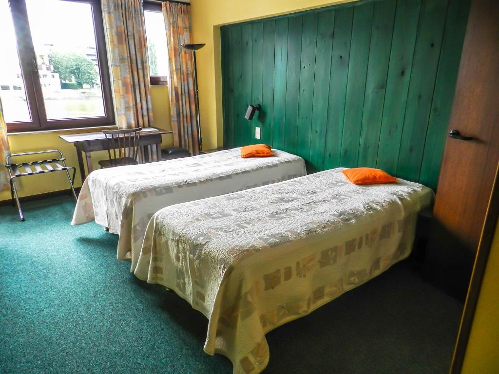 Postel nebo postele na pokoji v ubytování Hôtel du Fort