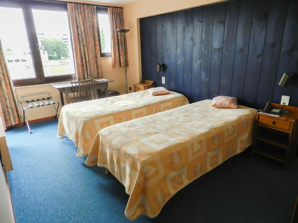 Postel nebo postele na pokoji v ubytování Hôtel du Fort