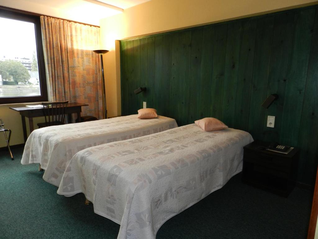 Postel nebo postele na pokoji v ubytování Hôtel du Fort