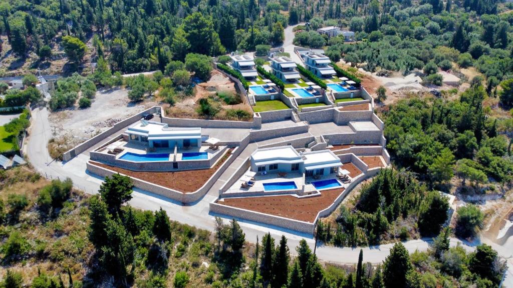 an aerial view of a building with blue roofs at Vento Villas in Agios Nikitas