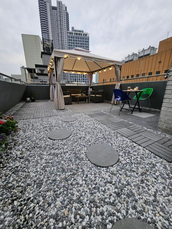 a patio with a table and a tent on a rooftop at T hotel in Seoul