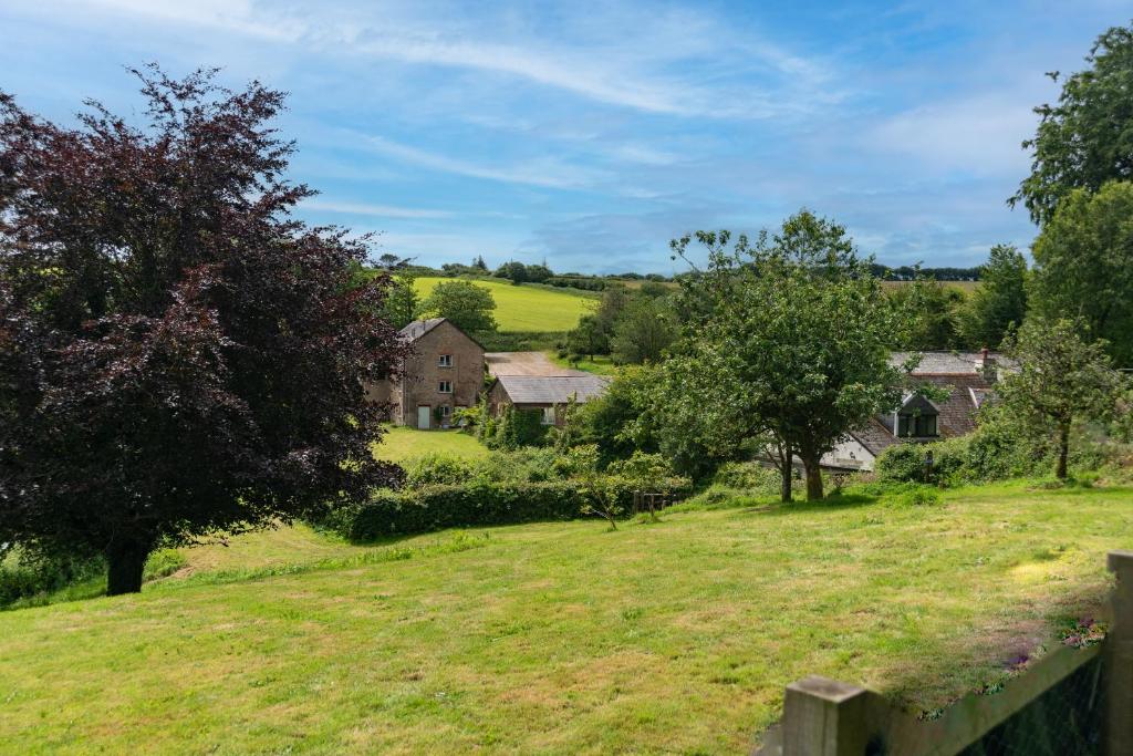 a view of a farm with houses and trees at The Stables - Old Mill Cottages in Ilfracombe