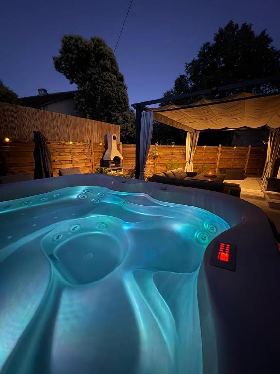 a hot tub in a backyard at night at Dalmatian Stone House Angela in Drniš