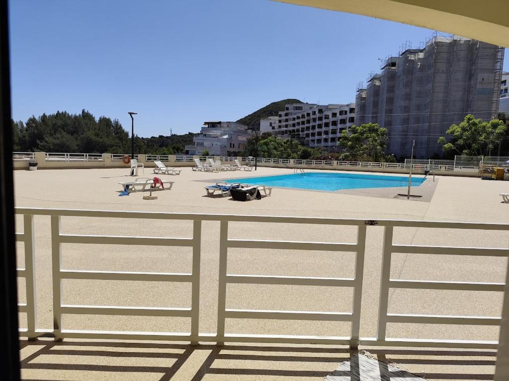 a view of a swimming pool behind a fence at BEACH house in Sesimbra