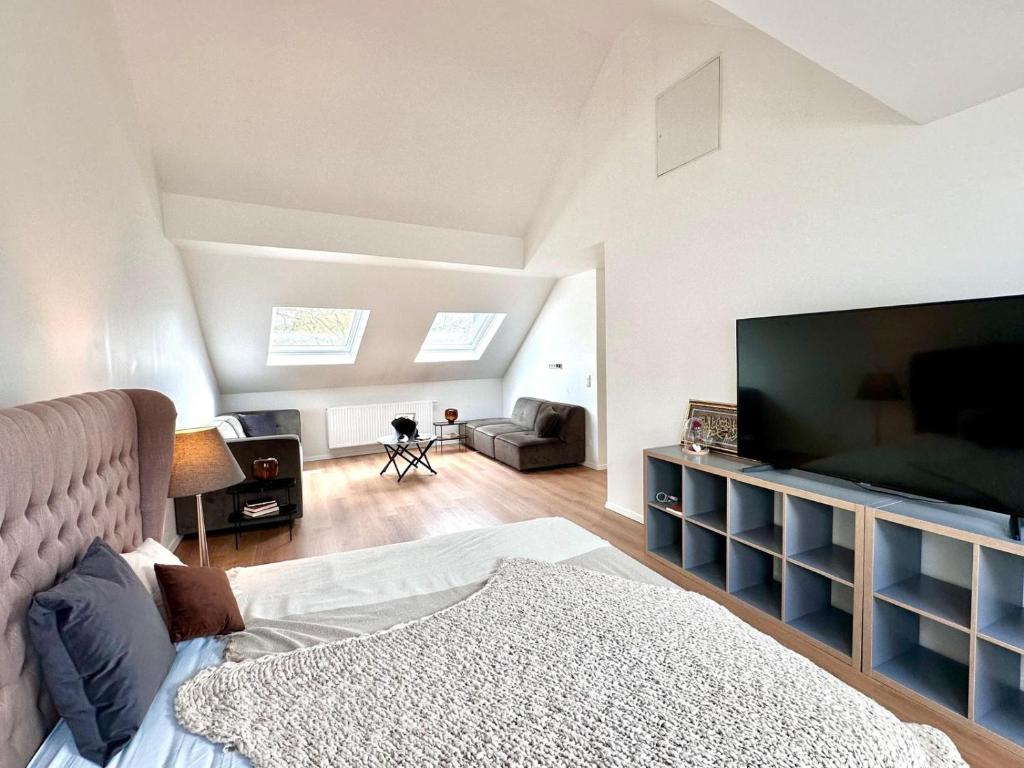 a bedroom with a large flat screen tv and a bed at Modern Country House in Merzig