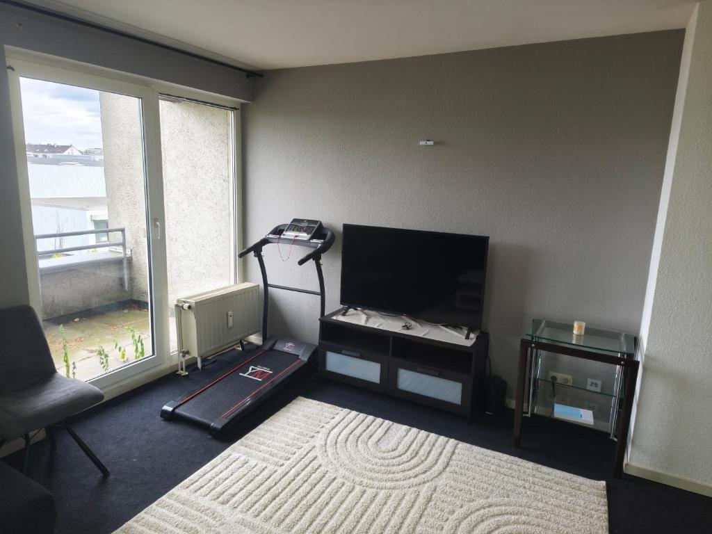 a living room with a tv and a large window at Bochum Wohnung in Bochum