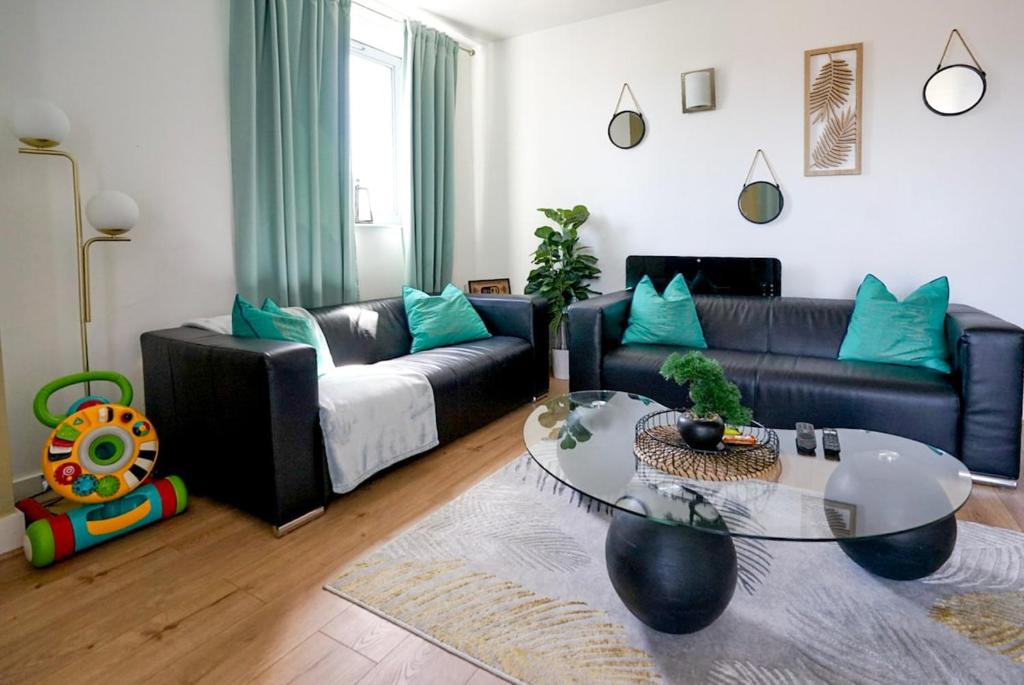a living room with a couch and a glass table at Stylish 2-Bed Apartment, Free Parking, Walk to Hospital & Uni in Sheffield