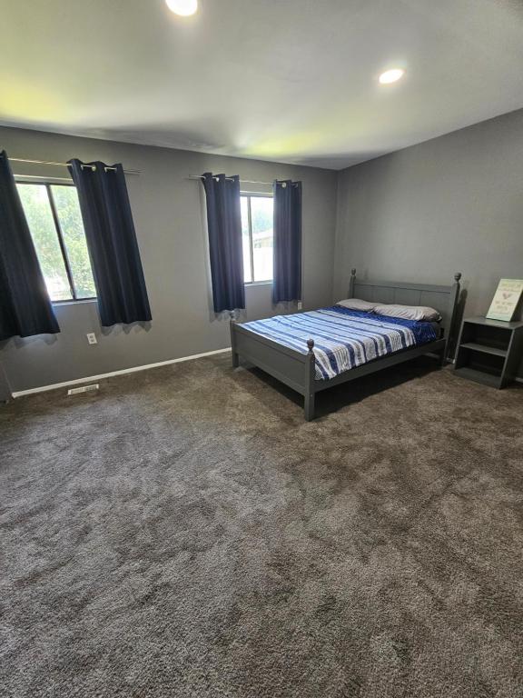 a bedroom with a bed and two windows at Cozy place! in Baltimore