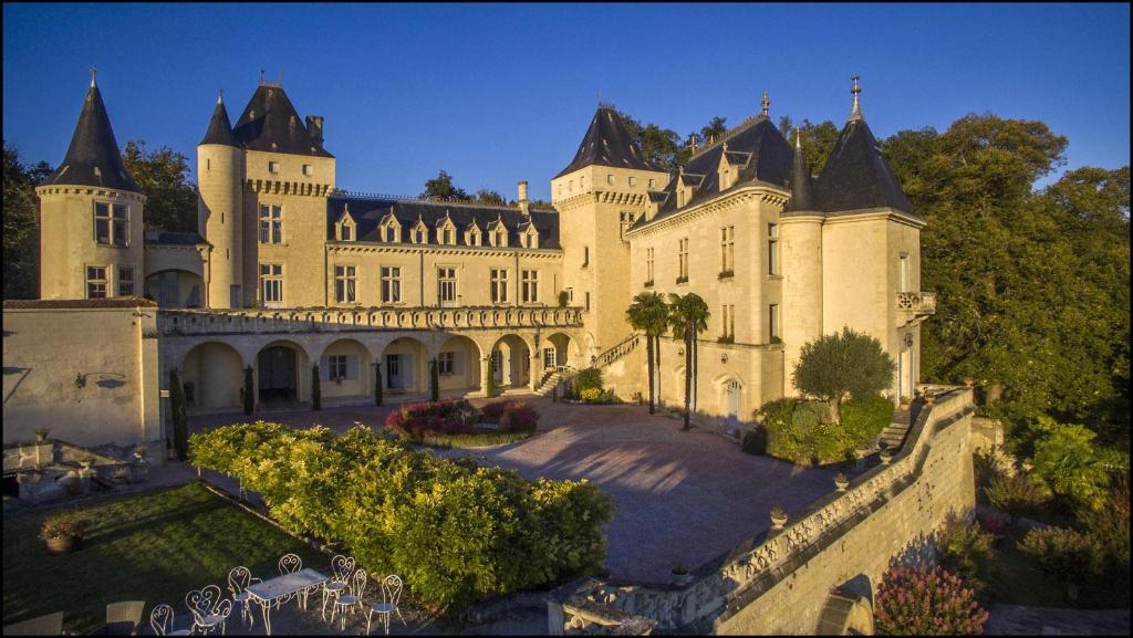 a large castle with a fence in front of it at CHATEAU DE LA RIVIERE in La Rivière