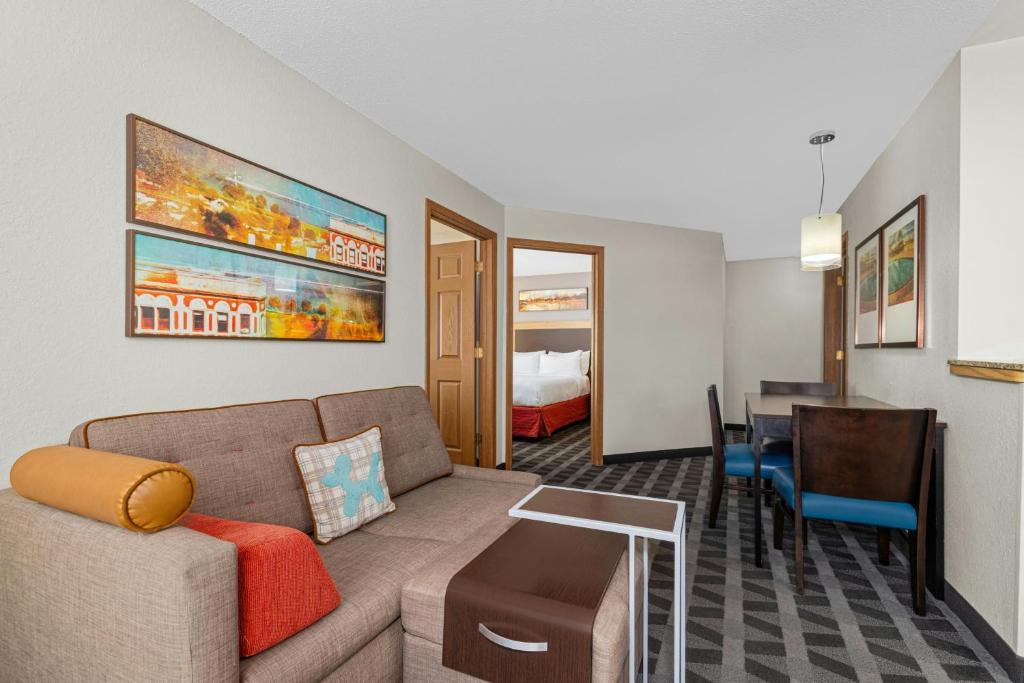 a living room with a couch and a dining room at TownePlace Suites by Marriott Brookfield in Brookfield