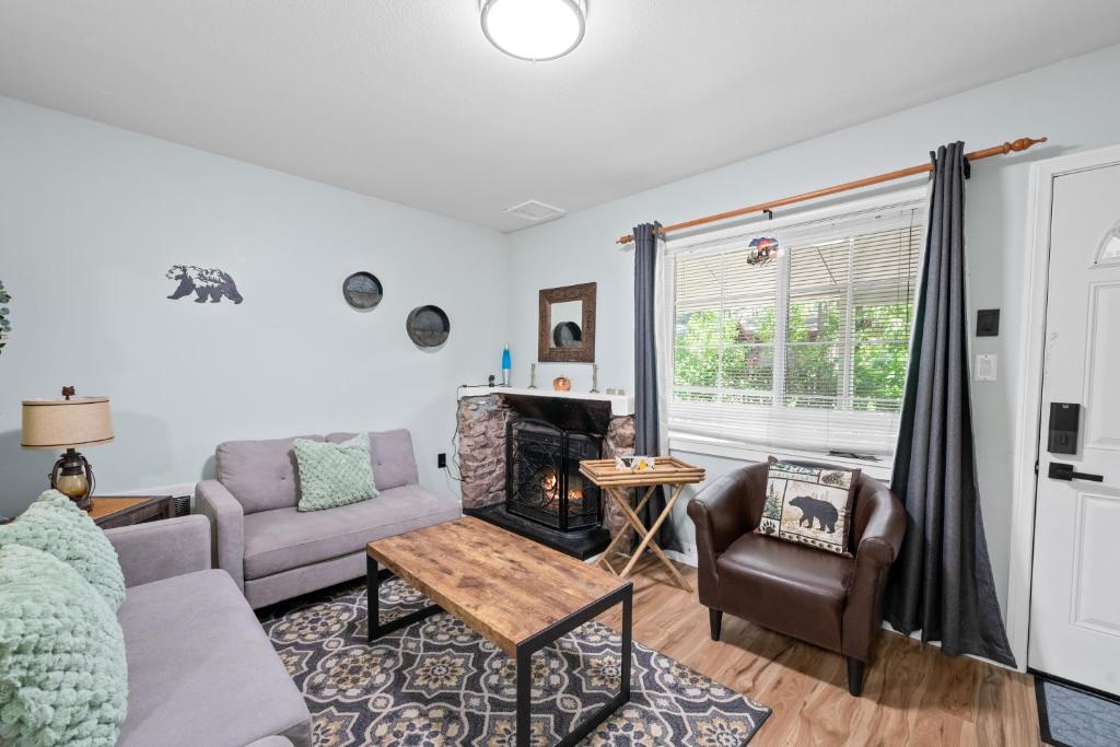 a living room with a couch and a fireplace at Jade Bear Retreat in Big Bear City