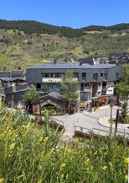 a large building in the middle of a mountain at Hotel & SPA Llop Gris in El Tarter