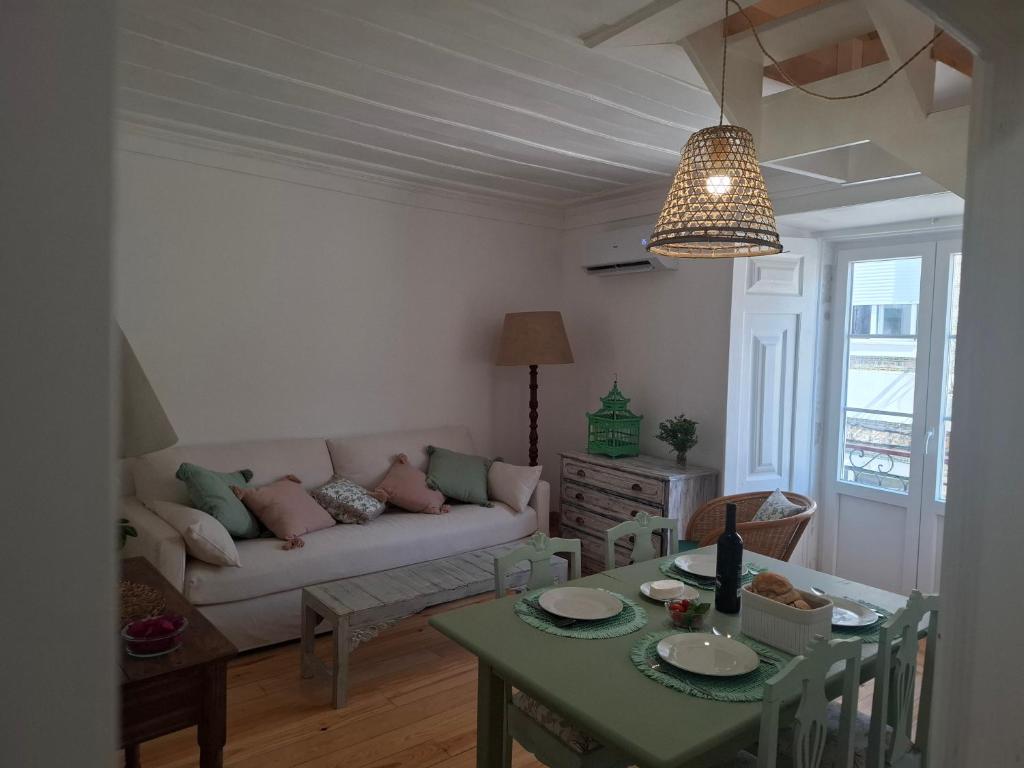 a living room with a couch and a table at FONTE NOVA Setubal in Setúbal
