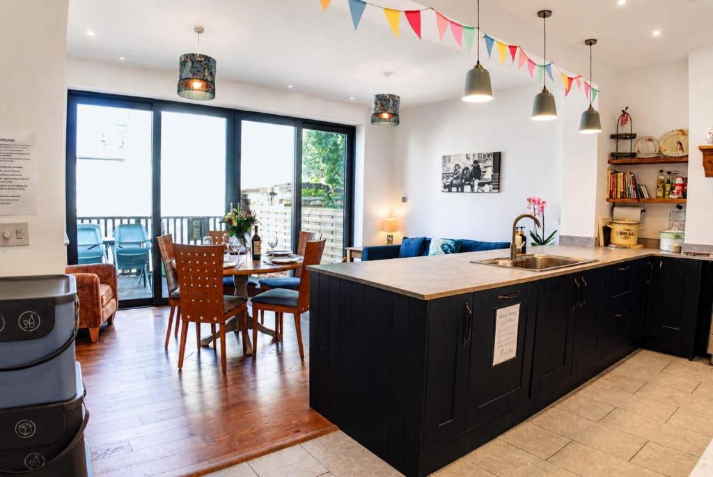 a kitchen and living room with a table and chairs at Spacious Pretty home in Old Totterdown in Bristol