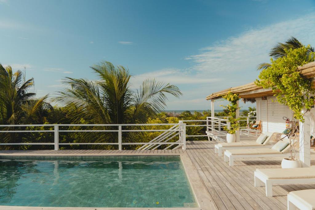 a patio with a swimming pool and a white fence at Villa Tomama by Preabeach Experience in Prea