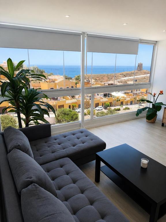 a living room with a couch and a large window at Luz y calma junto al mar in Lagos