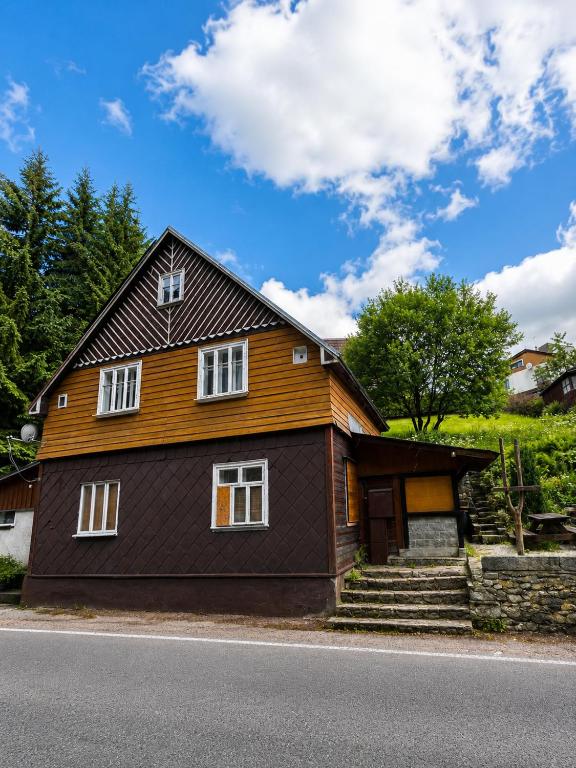 a brown house with a black roof at Basecamproll in Pec pod Snezkou
