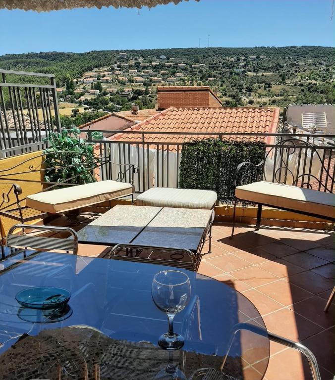 a table and chairs on a balcony with a view at Alojamiento Rural Ambite in Ambite