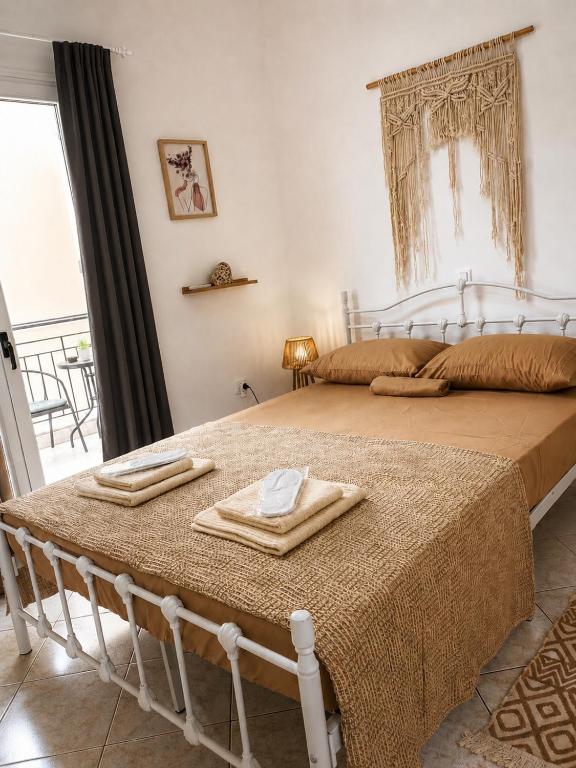 a bedroom with a bed with two towels on it at Eva's House in Amarynthos