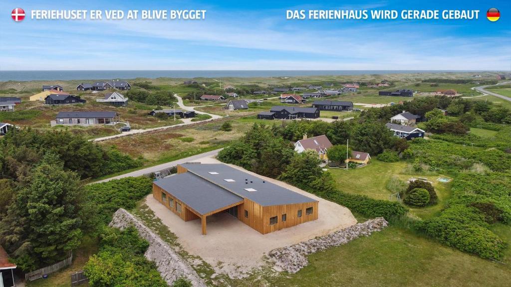 an overhead view of a home with a large building at Eksklusivt Luksusferiehus Med Pool Sj455 in Harboør
