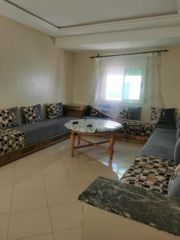 a living room with a couch and a coffee table at Martil calm apartment in Martil