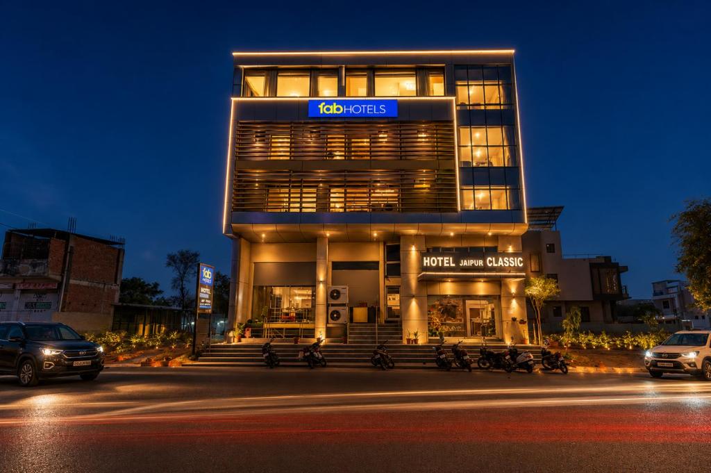 a building with cars parked in front of it at FabHotel Jaipur Classic - Vaishali Nagar in Jāmb