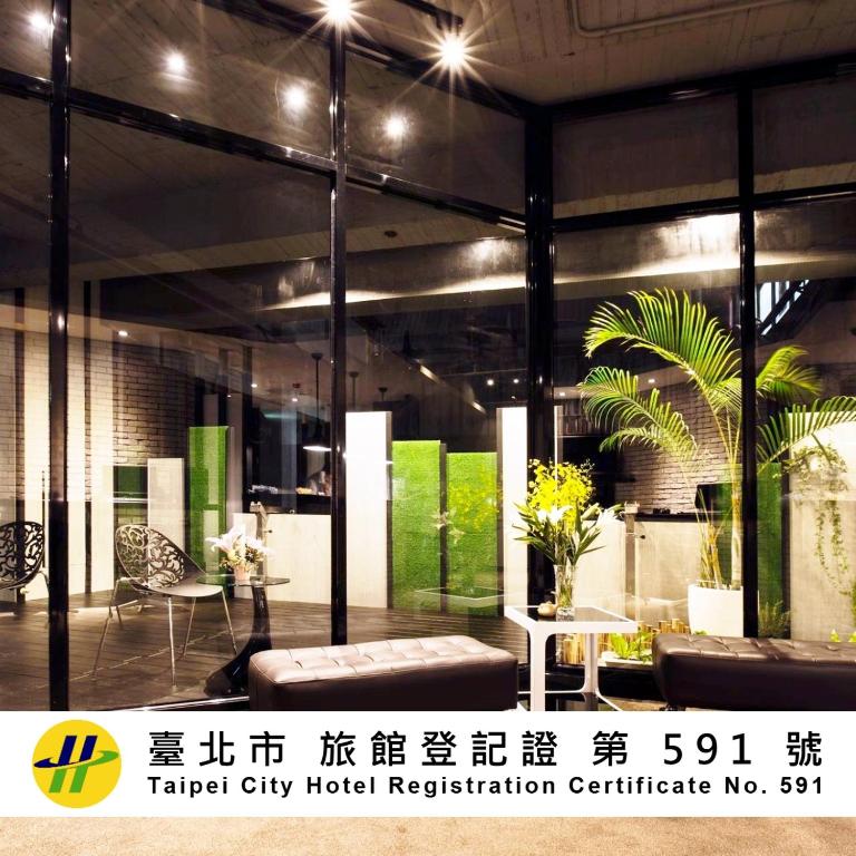 a lobby of a hotel with a large glass window at Queens Hotel II in Taipei