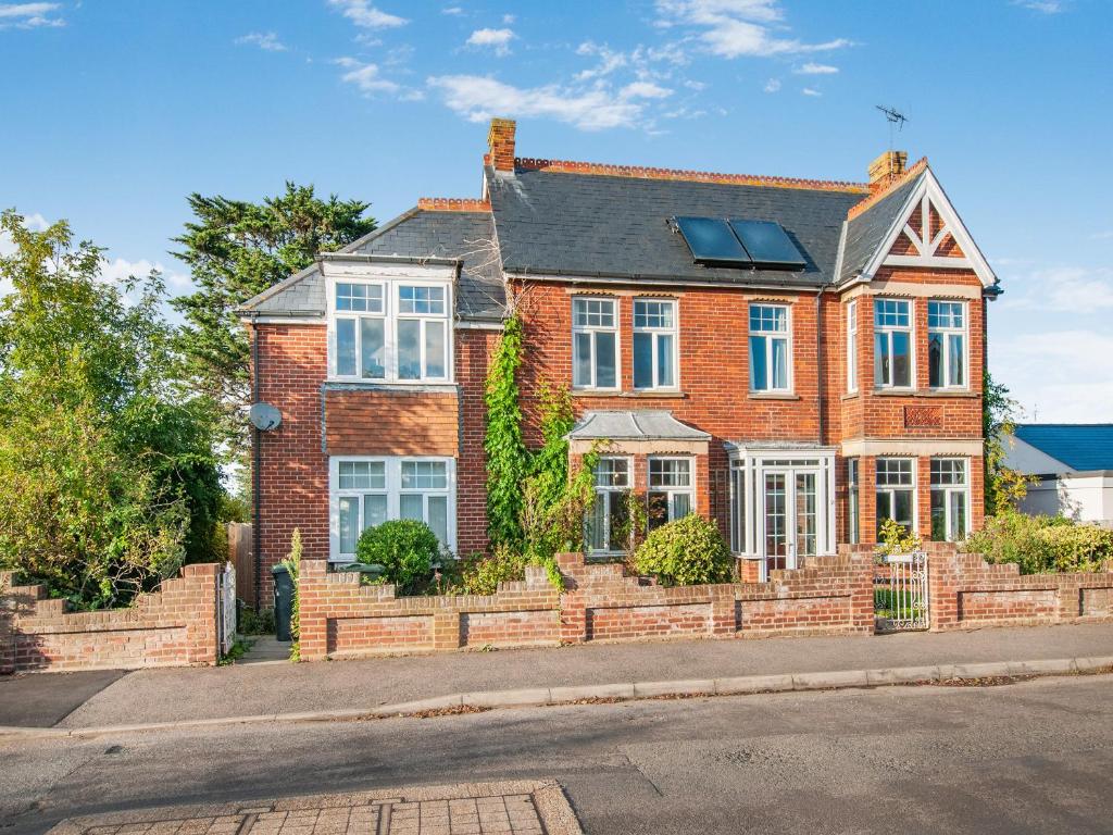 a red brick house with a solarium on it at The Old Doctors Manor House in Whitstable