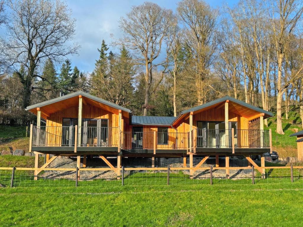 a large wooden house in a field at Poplar Lodge - Uk50625 in Welshpool