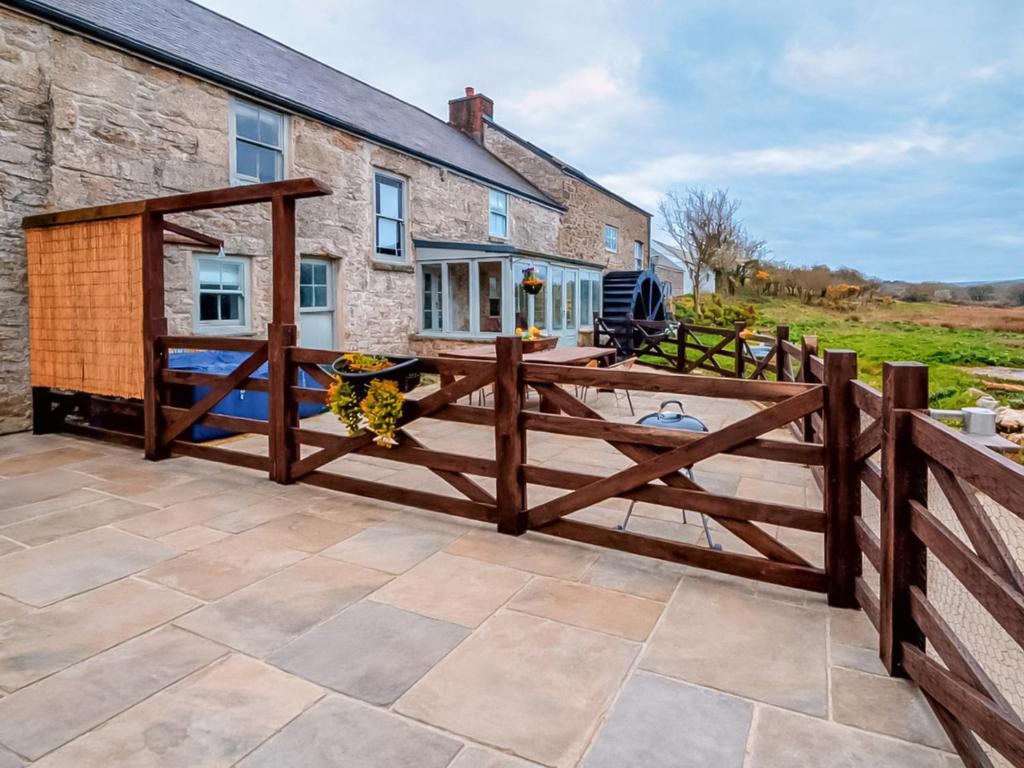 a wooden fence in front of a house at Mill House - Uk50646 in Falmouth