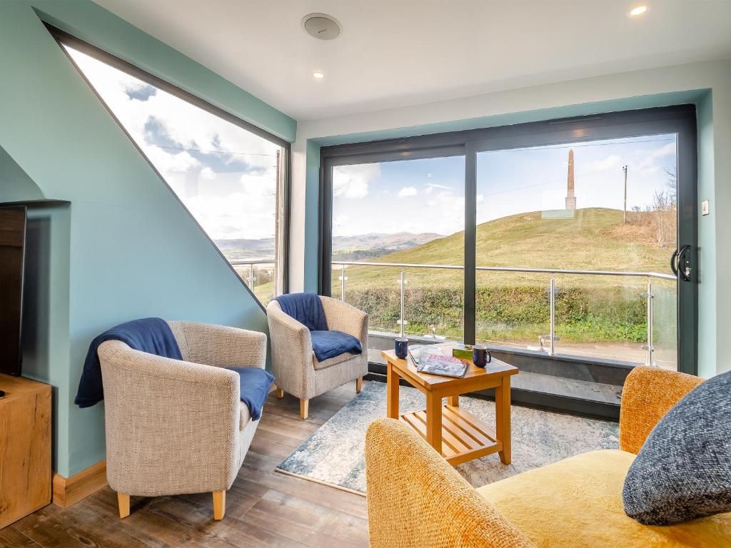 a living room with a view of a hill through a window at Blodfryn in Llandudno Junction