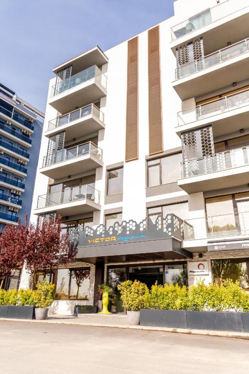 a building with a yellow fire hydrant in front of it at Vila Victor Mizuumi in Mamaia