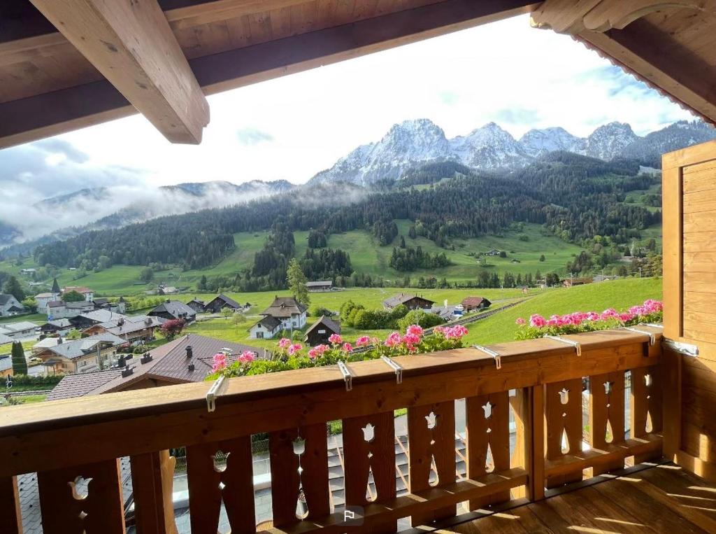 a balcony with a view of the mountains at Hôtel de Rougemont & Spa in Gstaad