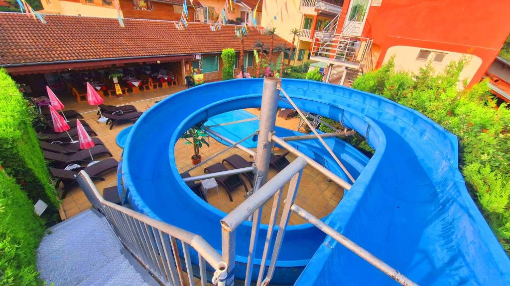 an overhead view of a blue water slide at Комплекс "Тера Верде" in Oreshak