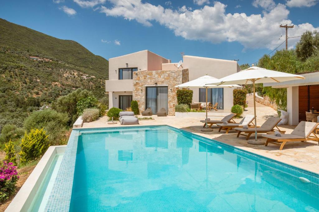 a villa with a swimming pool and a house at Villa Dara and Todd in Sivota