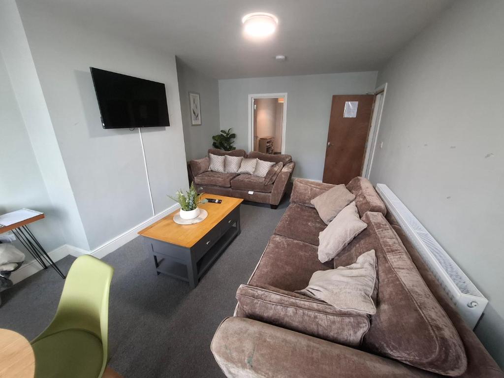 a living room with a couch and a table at Alice House Long stays in Sunderland