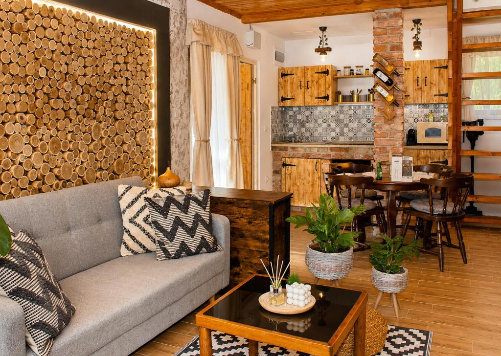 a living room with a couch and a table at Cityside Cottage in Eger