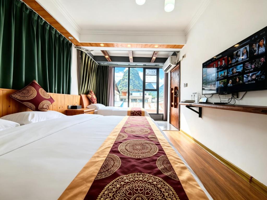 a hotel room with a large bed and a tv at 芮嘉民宿 阳朔西街店 in Yangshuo