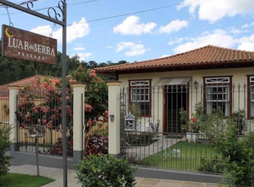 a house with a sign in front of it at Pousada Luar da Serra in Valença