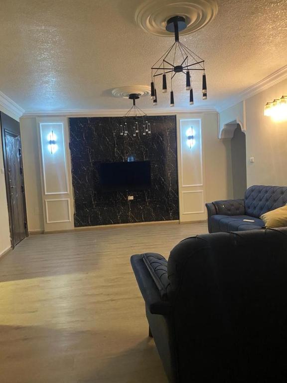 a living room with two couches and a fireplace at Bissan Condimenium in Amman