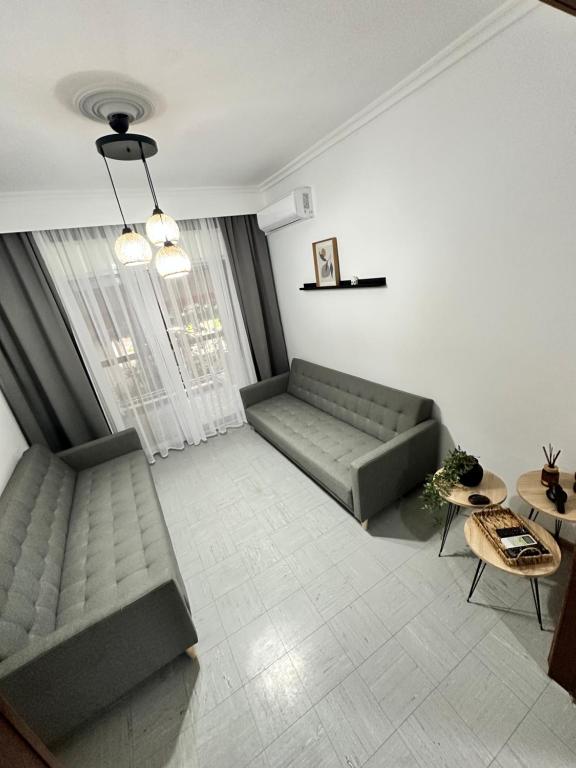 a living room with a couch and a table at GL House in Asprovalta