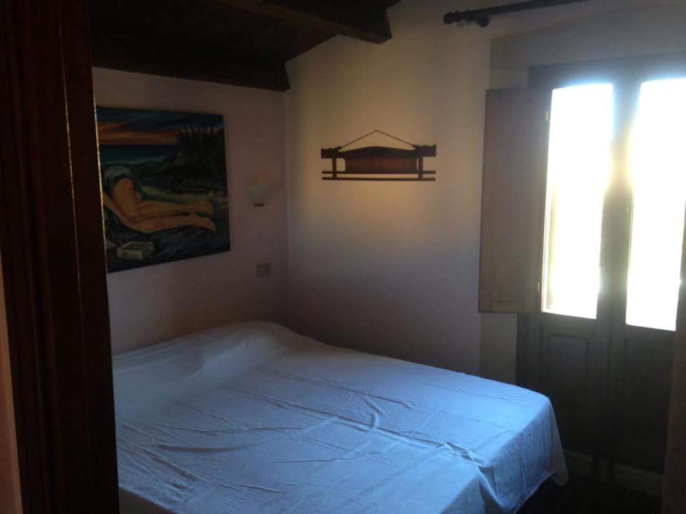 a bedroom with a bed in a room with a window at Le 3 tartarughe in Lascari