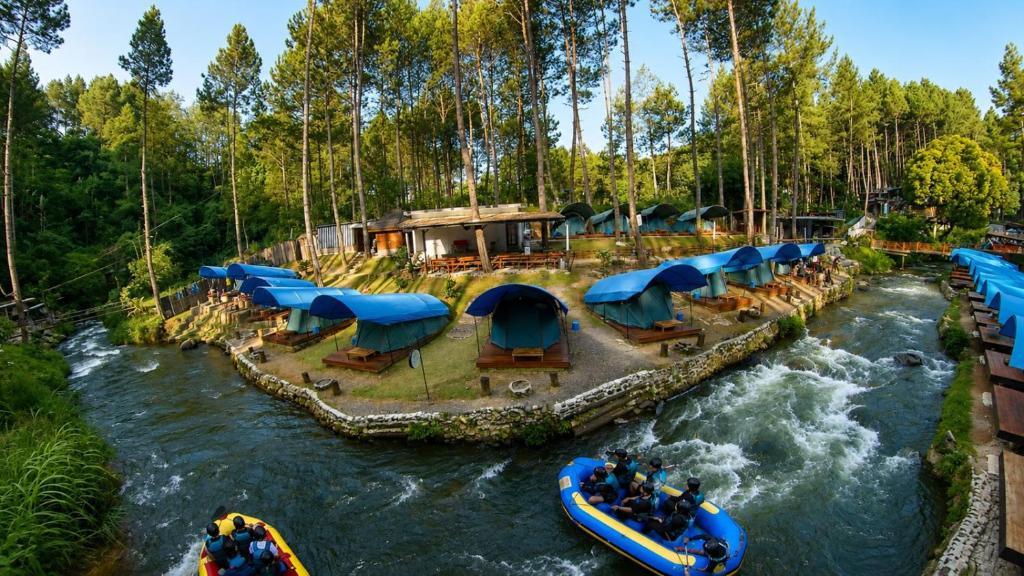 a group of people on a raft in a river at Batupineus Riverside in Palayangan