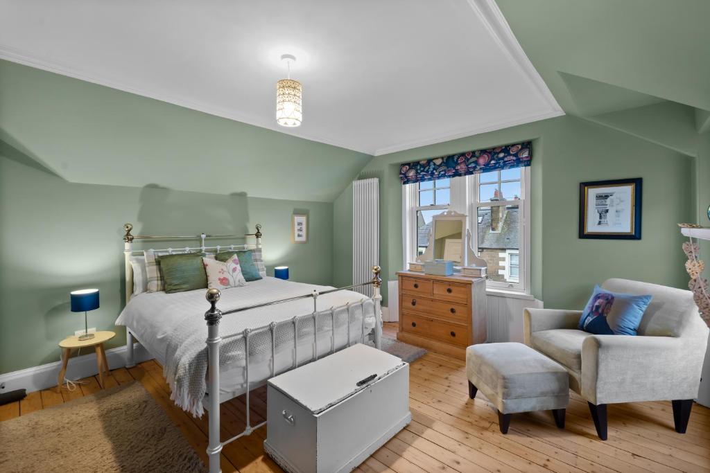a bedroom with a bed and a chair at Hermitage Suite - Stylish Shared Accommodation in Dundee